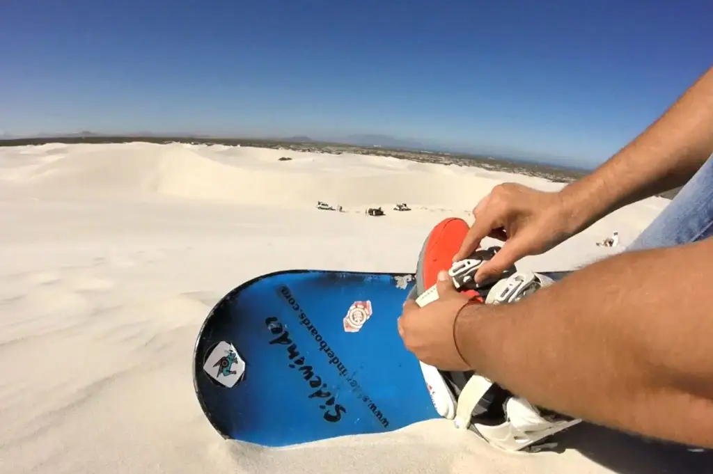 Clipping on a sandboard over shoe